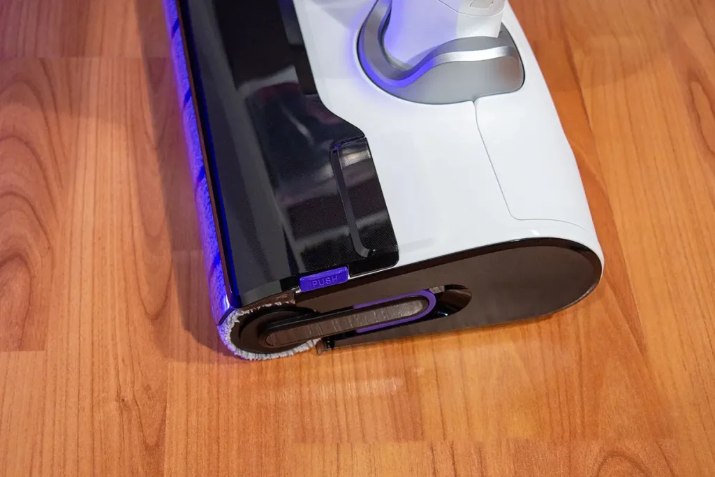 Głowica mopująca odkurzacza myjącego Tefal X-Clean 10 GF7540 z widocznym fioletowym przyciskiem PUSH służącym do zwalniania i demontażu wałka z mikrofibry